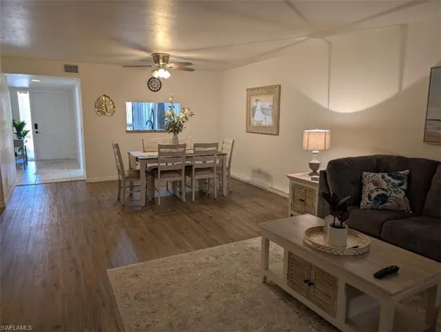 Living area with wood finished floors and a ceiling fan