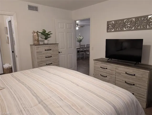 Bedroom with wood finished floors and ensuite bathroom
