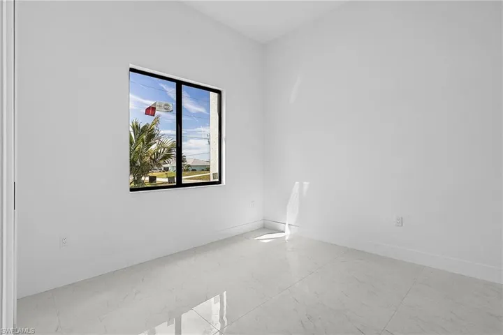 Empty room featuring marble finish floor and baseboards