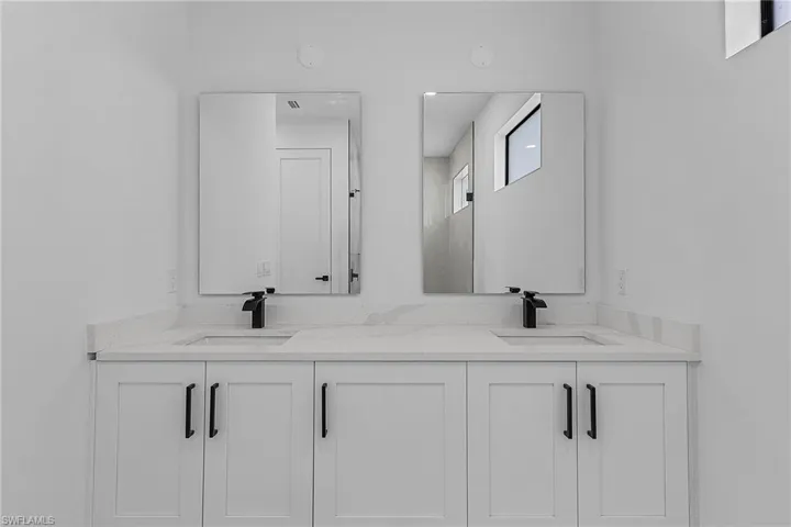 Full bath with double vanity and a sink