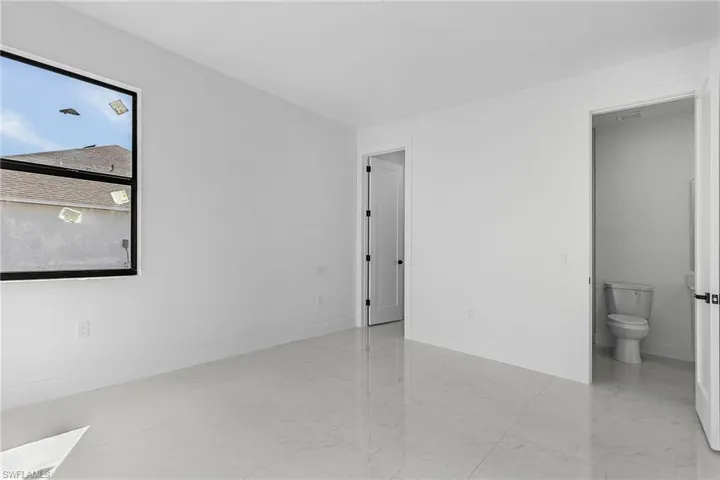 Unfurnished room with baseboards and marble finish floor