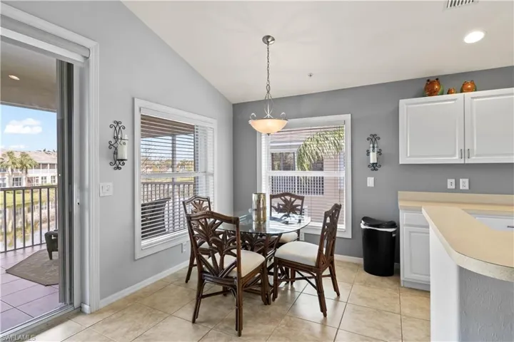 The breakfast nook is conveniently next to the kitchen, with access through sliding glass doors and views of the lake.