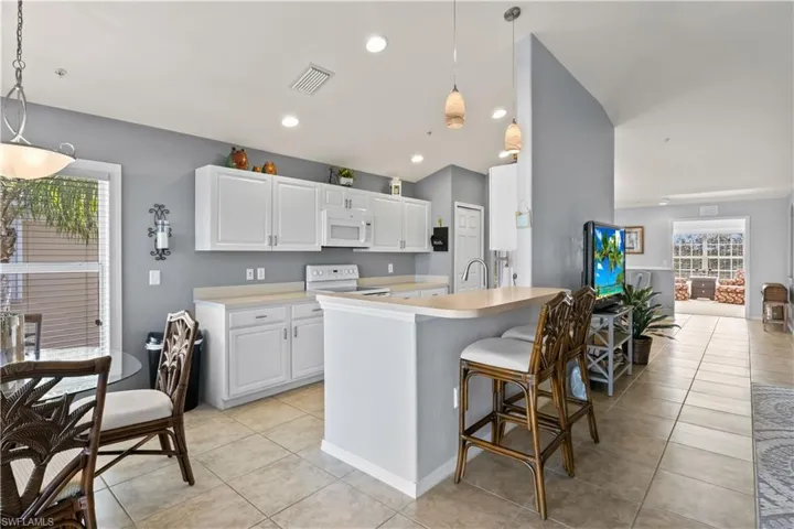 This useful island features plenty of countertop space for food prep and casual dining.