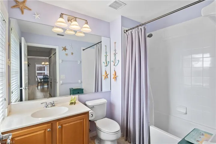 The guest bathroom features a desirable tub and shower combination.