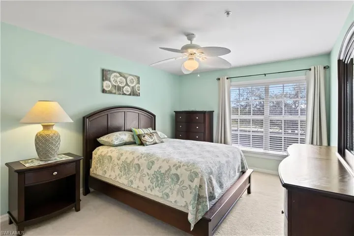 The primary bedroom features plenty of space and a lovely lake view.