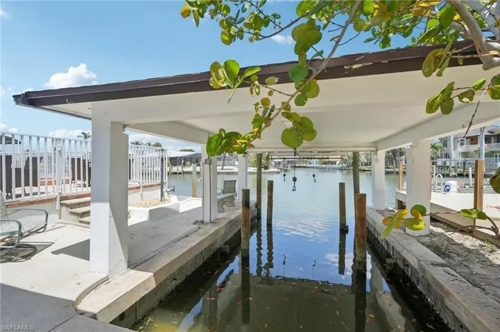 Dock area featuring a water view and boat lift