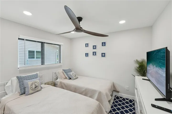 Bedroom with recessed lighting, ceiling fan, and baseboards