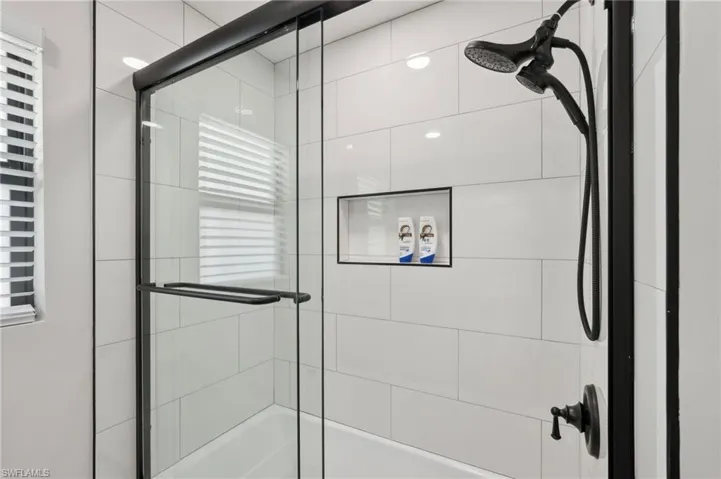 Bathroom featuring shower / bath combination with glass door