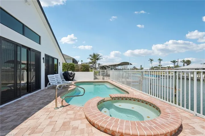 View of pool featuring a patio area and a pool with connected hot tub
