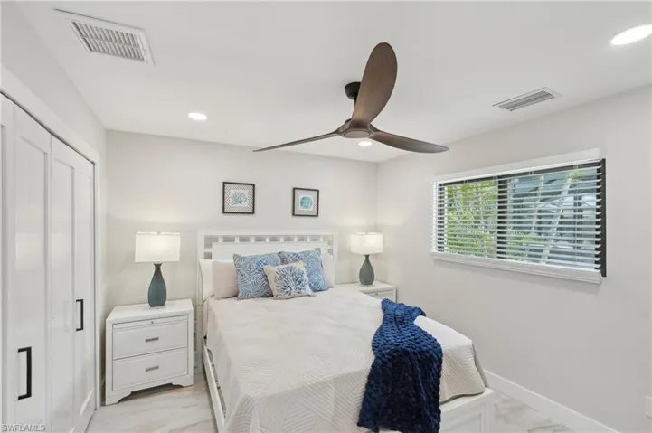 Bedroom featuring light marble finish floors, baseboards, recessed lighting, a ceiling fan, and a closet