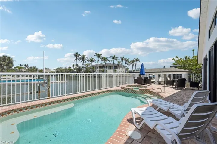 View of swimming pool with a patio area and a pool with connected hot tub