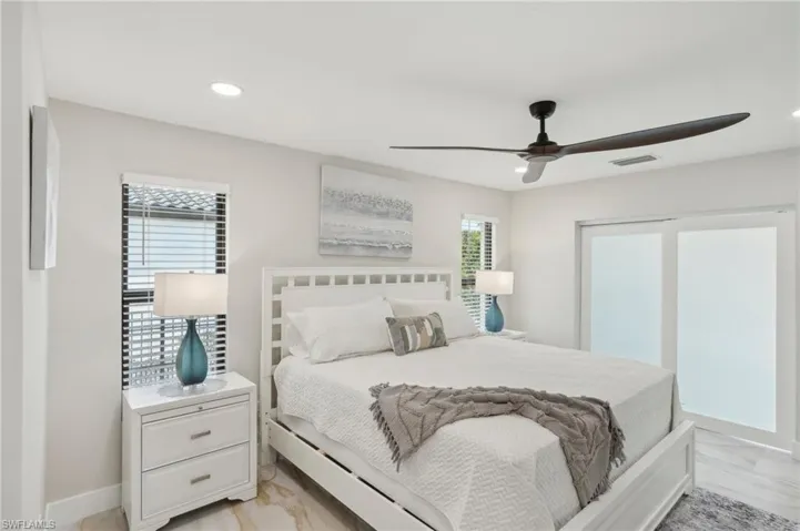 Bedroom with light marble finish floors, a ceiling fan, recessed lighting, baseboards, and a closet