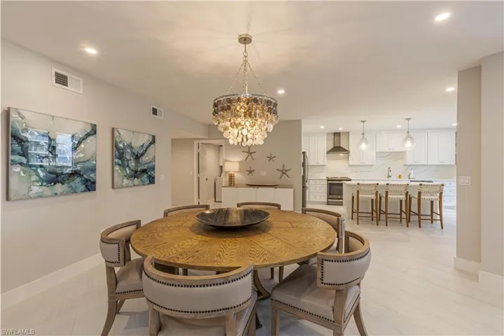 Dining space featuring sink and an inviting chandelier