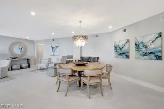 Dining space featuring baseboards, an inviting chandelier, visible vents, and recessed lighting