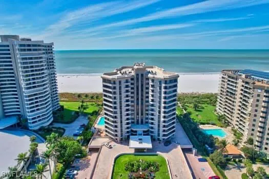 Bird's eye view featuring a water view and a beach view