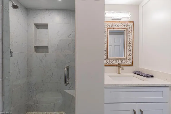 Bathroom with vanity and an enclosed shower