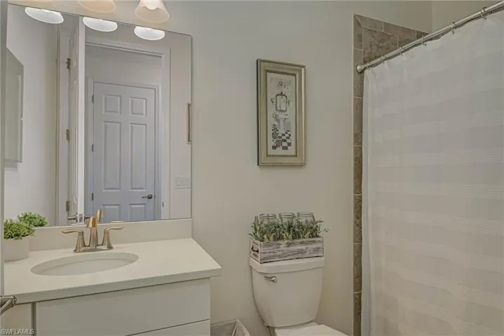 Bathroom featuring vanity and curtained shower