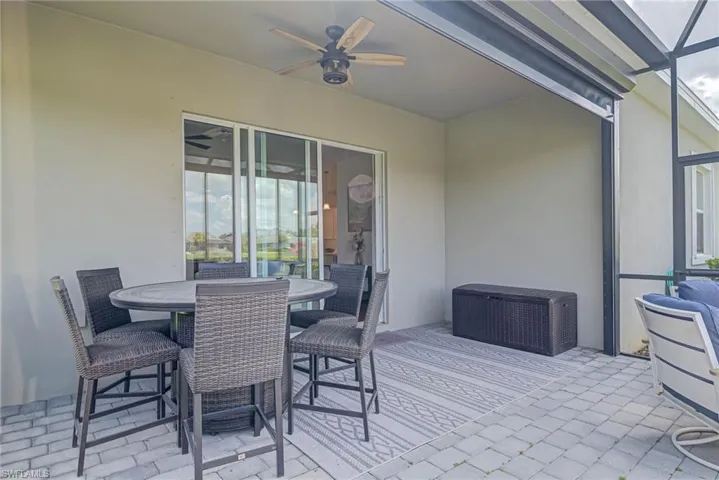 View of patio featuring outdoor dining space and ceiling fan
