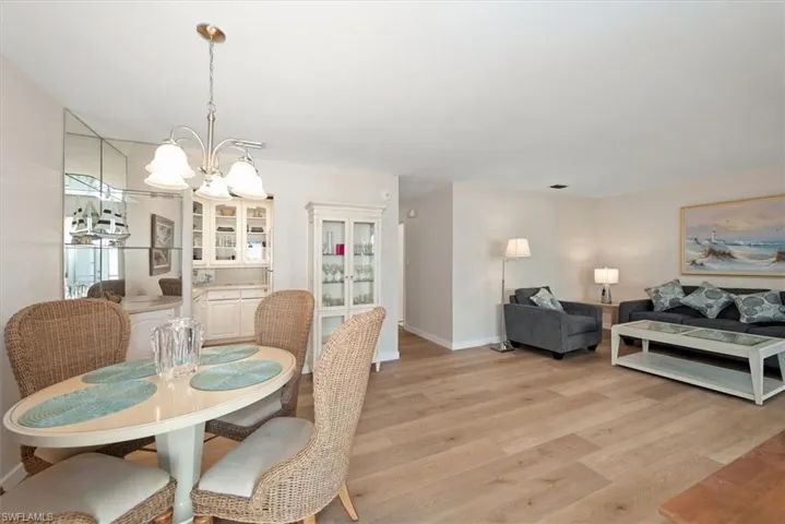 Dining area / living room with a chandelier and light wood-style floors