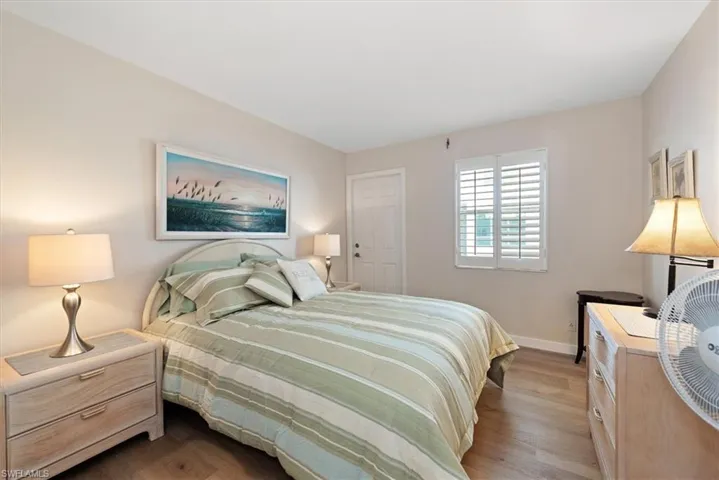 Bedroom featuring wood finished floors and baseboards