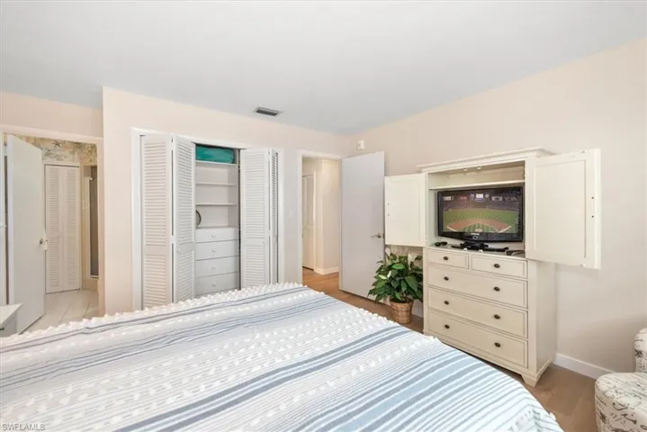Bedroom with a closet and light wood-style flooring