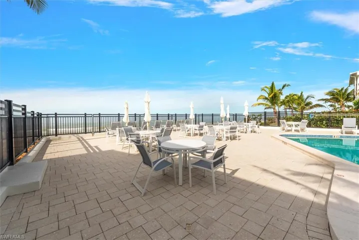 View of patio / terrace featuring a community pool and outdoor dining space