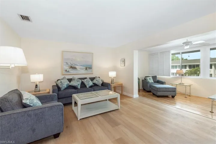 Living room featuring ceiling fan and light wood-style flooring