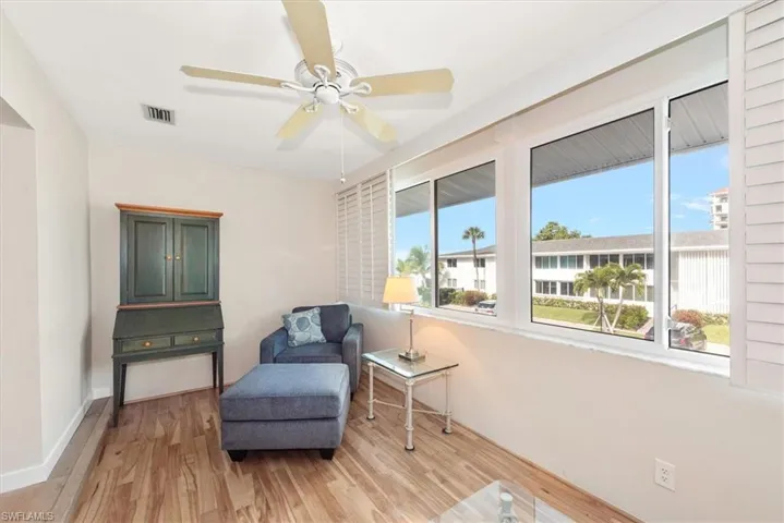 Sitting room featuring light wood finished floors and ceiling fan