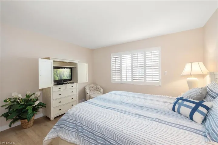 Bedroom featuring multiple windows and light wood-style floors