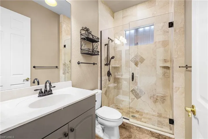 Full bathroom featuring vanity and a stall shower