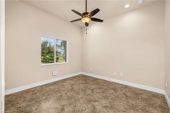 Bedroom with a ceiling fan, recessed lighting, and a tile flooring