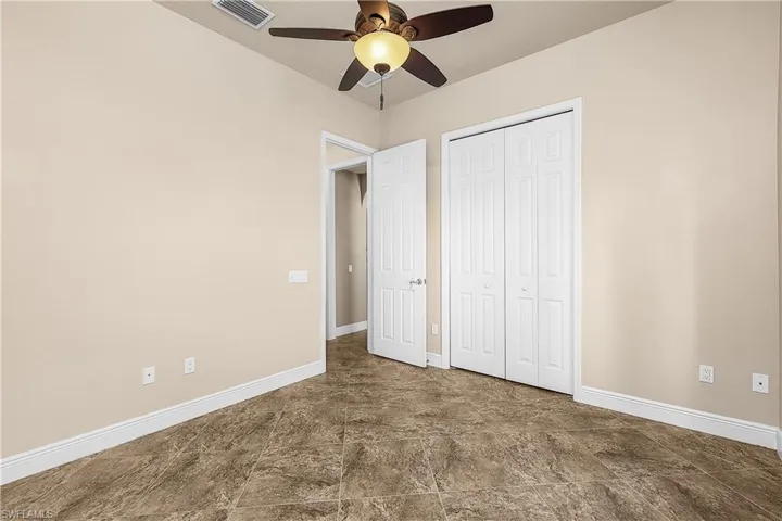Bedroom with ceiling fan and a closet