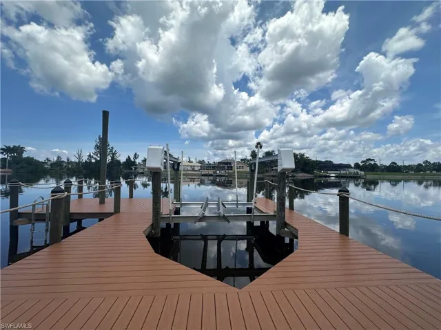 Dock with boat lift and a water view