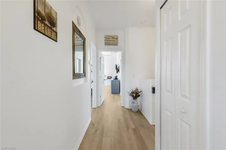 Hall with light wood-style flooring and baseboards