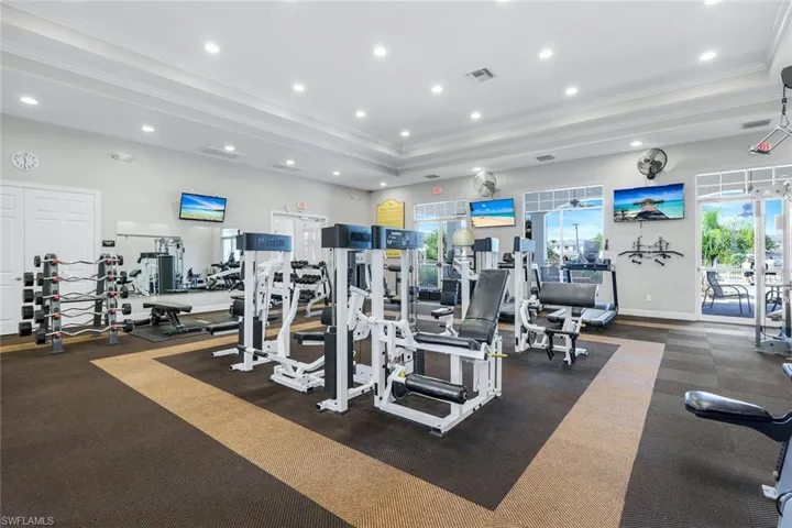 Exercise room with ornamental molding and recessed lighting