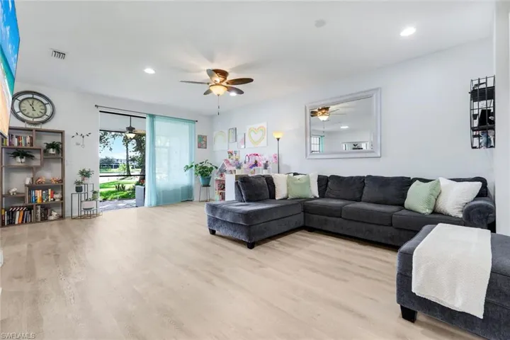 Living area with wood finished floors, ceiling fan, and recessed lighting