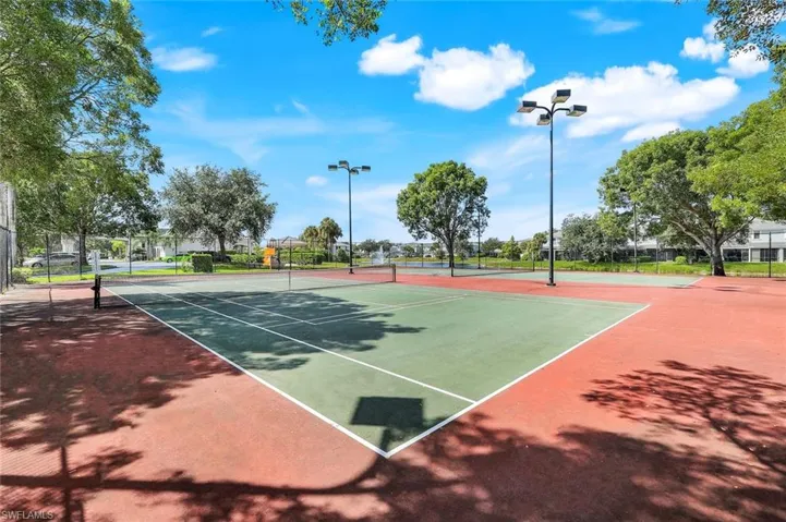View of tennis court with community basketball court