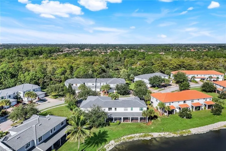 Aerial perspective of suburban area featuring a large body of water