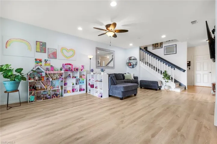 Playroom featuring a ceiling fan, light wood finished floors, and recessed lighting