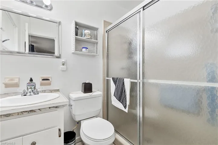 Bathroom featuring vanity and a stall shower