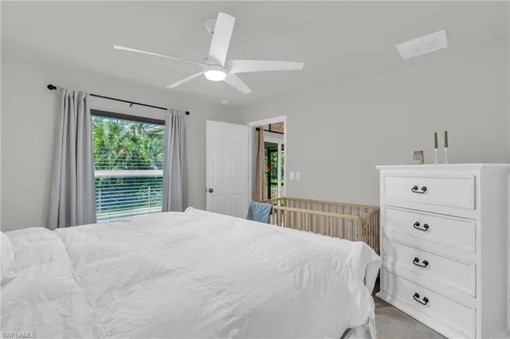 Carpeted bedroom featuring ceiling fan