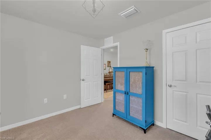 Bedroom featuring light colored carpet