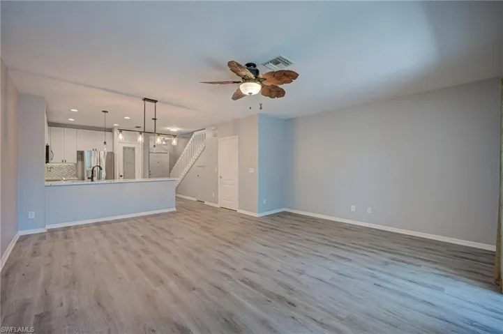 Unfurnished living room featuring a ceiling fan, light wood-style flooring, and recessed lighting
