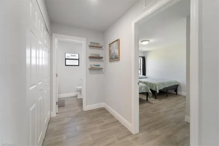 Corridor featuring baseboards and wood finish floors