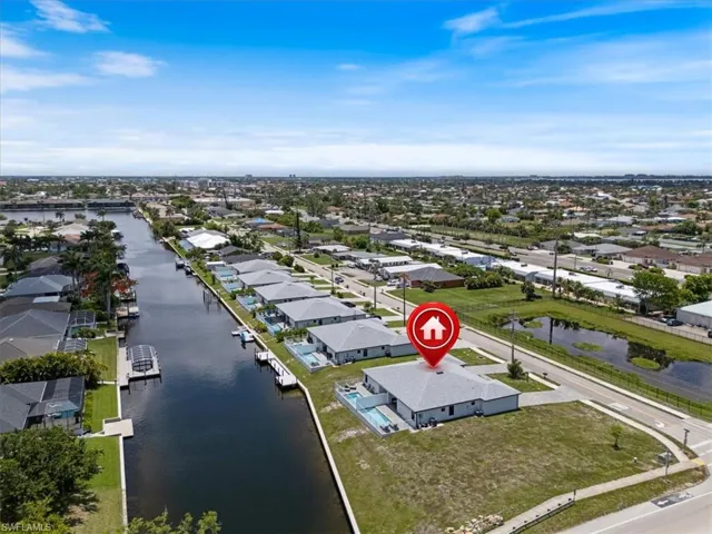 Aerial perspective of suburban area featuring a large body of water