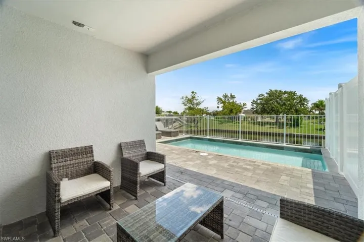 View of swimming pool with patio surround and a fenced backyard
