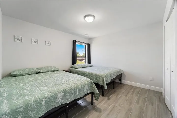 Bedroom with a closet and wood tiled floors
