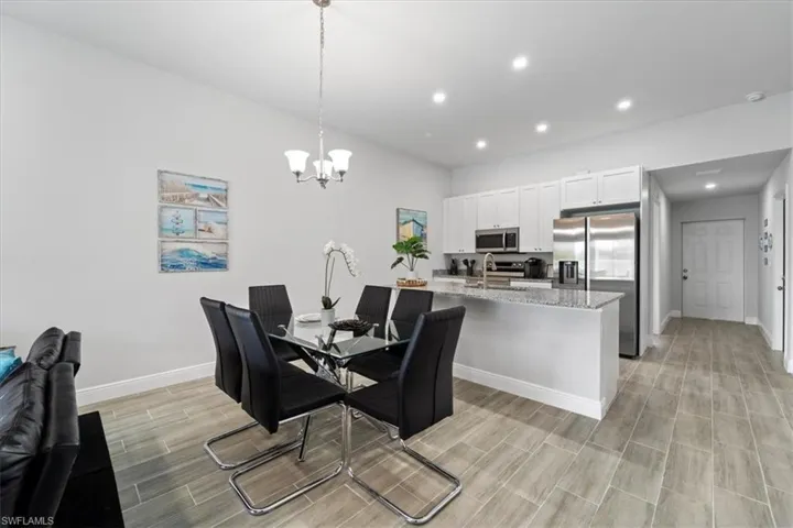 Dining room with wood finish floors and a chandelier
