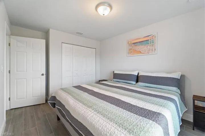 Bedroom with a closet and wood tiled floors