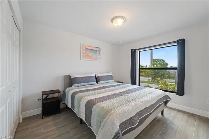 Bedroom featuring wood tiled floors and a closet